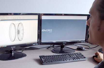 Transparent Vossen wheel being viewed by an employee on a computer